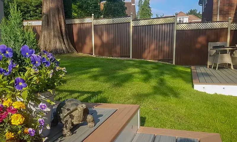 ColourFence coloured steel fence in brown with cream trellis top